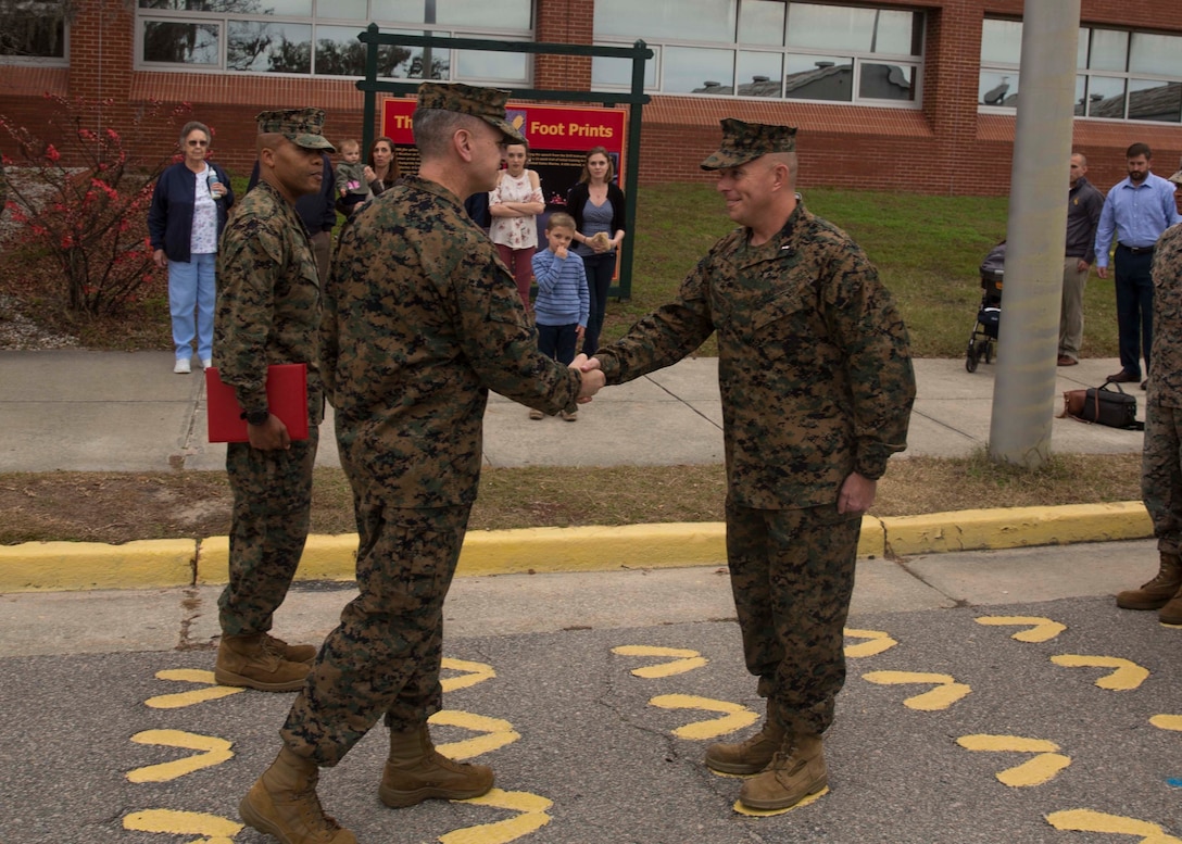 U.S. Marine Corps Chief Warrant Officer Matthew Kessinger, personnel officer of 6th Marine Corps District, right, shakes hands with Col. William C. Gray, commanding officer of 6th MCD, during his promotion to chief warrant officer five aboard Marine Corps Recruit Depot Parris Island, South Carolina, Dec. 19, 2018. Kessinger, a native of Louisville, Kentucky, has currently served 28 years in the Marine Corps. (U.S. Marine Corps photo by Lance Cpl. Jack A. E. Rigsby)