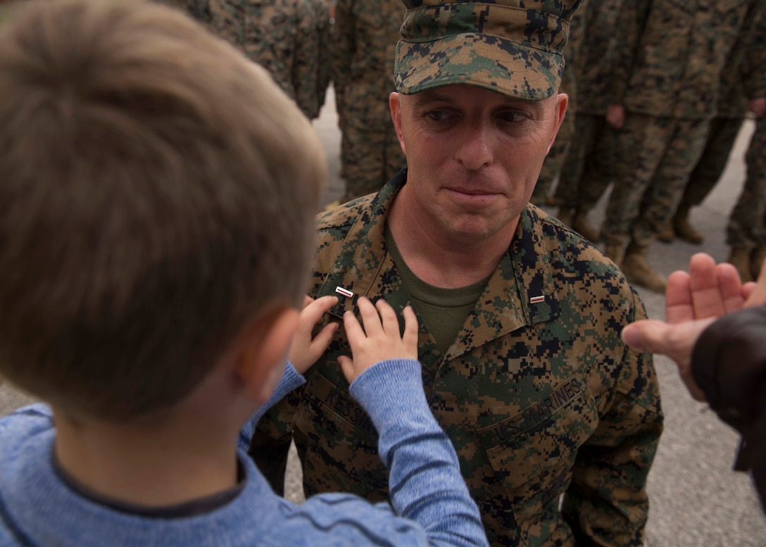 Nicholas Kessinger pins the rank of chief warrant officer five onto Chief Warrant Officer Matthew Kessinger, personnel officer of 6th Marine Corps District, at Marine Corps Recruit Depot Parris Island, South Carolina, Dec. 19, 2018. Kessinger, a native of Louisville, Kentucky, has currently served 28 years in the Marine Corps. (U.S. Marine Corps photo by Lance Cpl. Jack A. E. Rigsby)