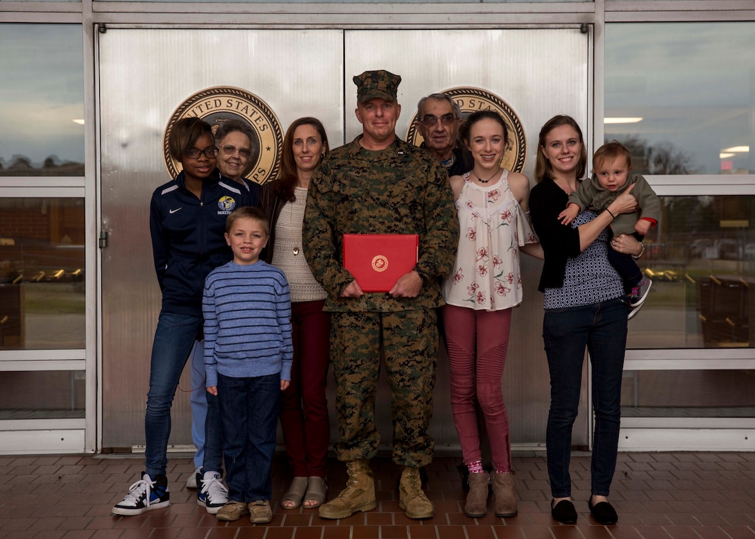 U.S. Marine Corps Chief Warrant Officer Matthew Kessinger, personnel officer of 6th Marine Corps District, poses for a photo with his family after his promotion to chief warrant officer five aboard Marine Corps Recruit Depot Parris Island, South Carolina, Dec. 19, 2018. Kessinger, a native of Louisville, Kentucky, has currently served 28 years in the Marine Corps. (U.S. Marine Corps photo by Lance Cpl. Jack A. E. Rigsby)