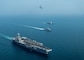 From left to right, the aircraft carrier USS John C. Stennis (CVN 74), the Royal Australian Navy frigate HMAS Ballarat (FFH 155) and the guided-missile cruiser USS Mobile Bay (CG 53) sail in formation as a C-2A Greyhound, assigned to Fleet Logistics Combat Support Squadron (VRC) 30, detachment 4, conducts a flyover in the Arabian Gulf, Jan. 16, 2019, during exercise Intrepid Sentinel. Intrepid Sentinel brings together the John C. Stennis Strike Group, France’s Marine Nationale, United Kingdom’s Royal Navy and the Royal Australian Navy for a multinational exercise designed to enhance war fighting readiness and interoperability between allies and partners. The John C. Stennis Strike Group is deployed to the U.S. 5th Fleet area of operations in support of naval operations to ensure maritime stability and security in the Central Region, connecting the Mediterranean and the Pacific through the western Indian Ocean and three strategic choke points.  (U.S. Navy photo by Mass Communication Specialist 3rd Class Jake Greenberg)