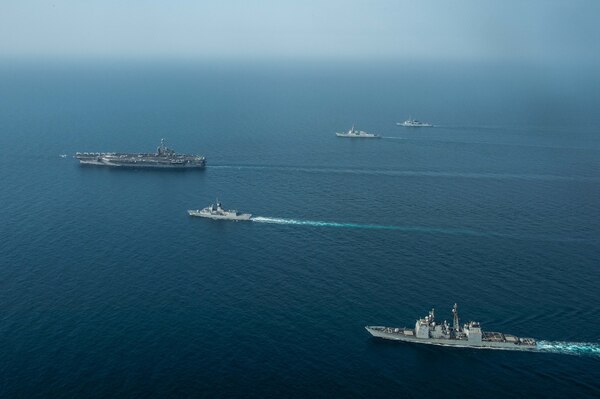 An F/A-18E Super Hornet, assigned to Carrier Air Wing (CVW) 9, launches from the aircraft carrier USS John C. Stennis (CVN 74), left, during a formation sailing evolution with, from the top, France’s Marine Nationale air defense destroyer FS Cassard (D 614), the guided-missile destroyer USS Spruance (DDG 111), the Royal Australian Navy frigate HMAS Ballarat (FFH 155) and the guided-missile cruiser USS Mobile Bay (CG 53) in the Arabian Gulf, Jan. 16, 2019, during exercise Intrepid Sentinel. Intrepid Sentinel brings together the John C. Stennis Strike Group, France’s Marine Nationale, United Kingdom’s Royal Navy and the Royal Australian Navy for a multinational exercise designed to enhance war fighting readiness and interoperability between allies and partners. The John C. Stennis Strike Group is deployed to the U.S. 5th Fleet area of operations in support of naval operations to ensure maritime stability and security in the Central Region, connecting the Mediterranean and the Pacific through the western Indian Ocean and three strategic choke points.  (U.S. Navy photo by Mass Communication Specialist 3rd Class Jake Greenberg)