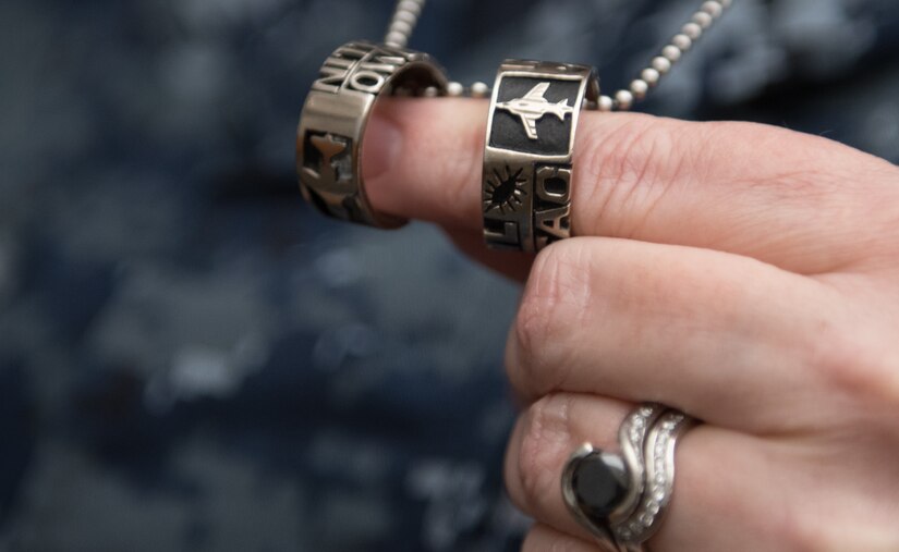 U.S. Navy Commander Kerry Beasley holds two 497th Tactical Fighter Squadron rings at Joint Base Langley-Eustis, Virginia, Jan. 9, 2019.