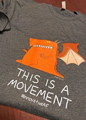 The 412th Test Wing commander and the Hustle Squad Innovation Team introduced a new mascot -- Eddie the Dragon, who is hungry for innovative ideas. Compimentary t-shirts were passed out to different units on base Jan. 15. (U.S. Air Force photo by Kenji Thuloweit)