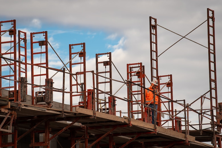 A masonry worker with the Army Corps of Engineers walks across scaffolding on the construction site of the 56th Communications Squadron building, Jan. 14, 2019 at Luke Air Force Base, Ariz.