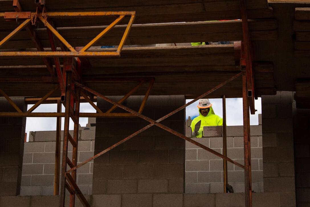 A masonry worker with the Army Corps of Engineers applies grout to concrete blocks, Jan. 14, 2019 at Luke Air Force Base, Ariz.
