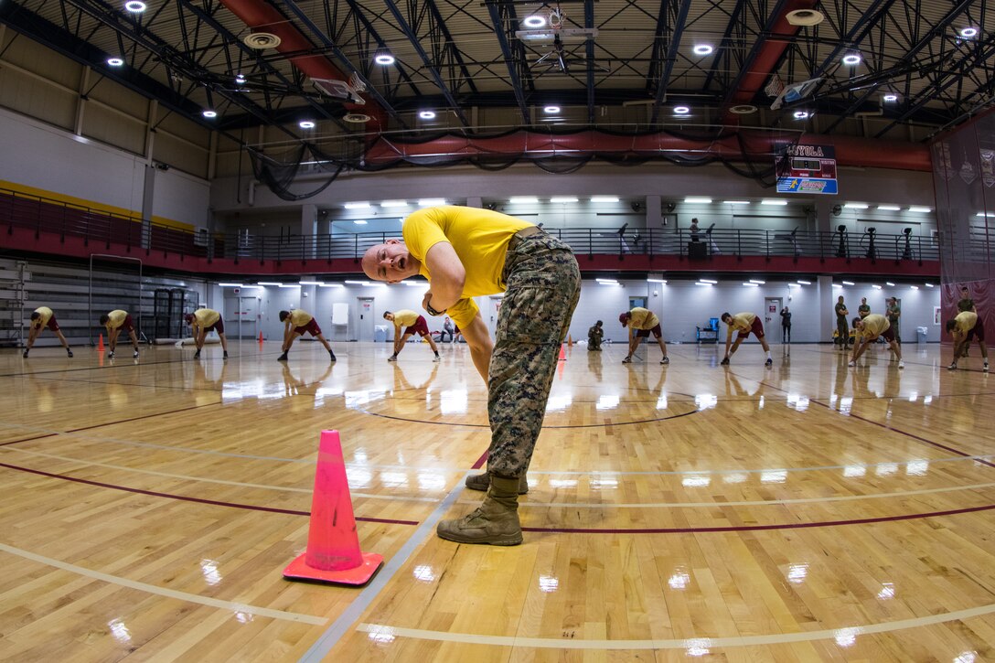 Master Sgt. Bryan Smith, assistant Marine officer instructor for Tulane University, leads a stretching exercise with members of the Loyola University New Orleans baseball team, at Loyola University New Orleans, Jan. 12, 2019. Smith and Marines with Marine Forces Reserve led a workout session that was physically and mentally challenging. The workout session was comprised of four events; incentive training, shamrock drill, Marine Corps Martial Arts Program demonstrations and casualty evacuation drills. (U.S. Marine Corps photo by Sgt. Andy O. Martinez)