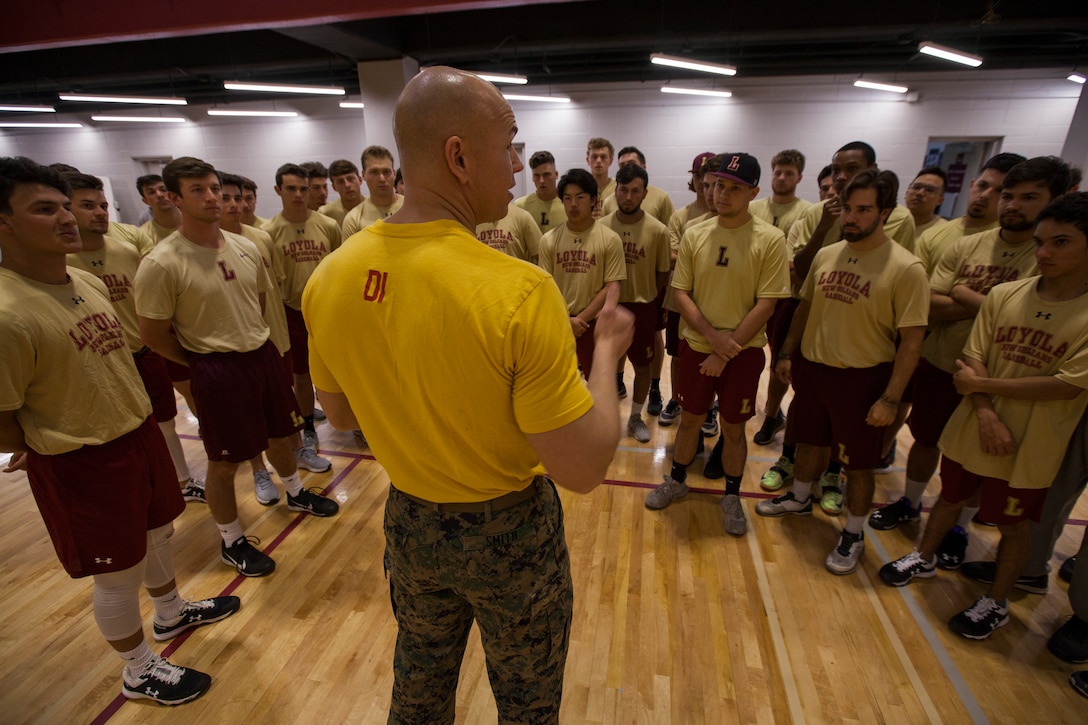 Master Sgt. Bryan Smith, assistant Marine officer instructor for Tulane University, talks to members of the Loyola University New Orleans baseball team before a workout, at Loyola University New Orleans, Jan. 12, 2019. Smith along with Marines from Marine Forces Reserve, provided a workout that was physically challenging to the participants but also focused on teamwork and leadership. The workout session was comprised of four events; incentive training, shamrock drill, Marine Corps Martial Arts Program demonstrations and casualty evacuation drills. (U.S. Marine Corps photo by Cpl. Niles Lee)