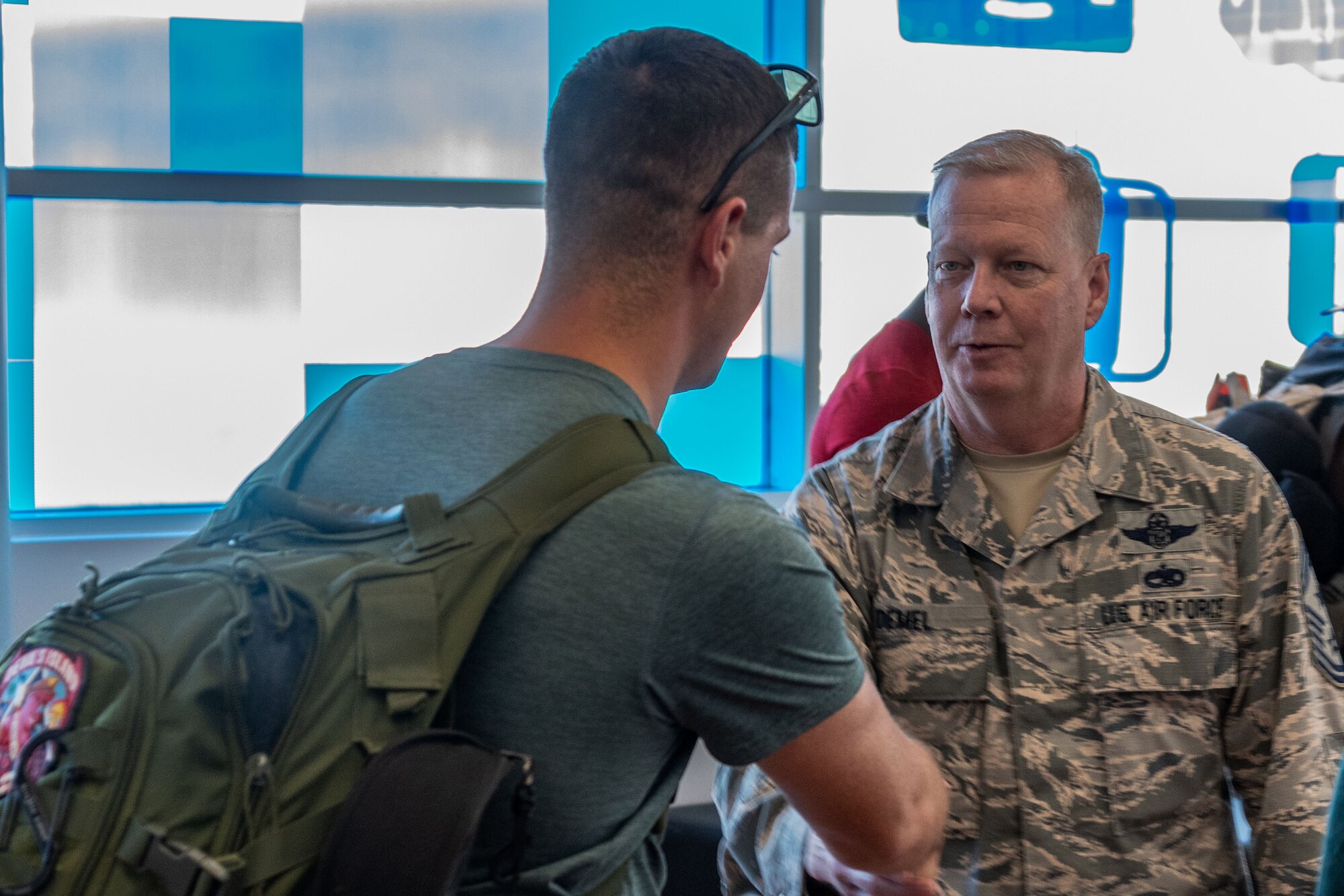 U.S. Air Force Chief Master Sgt. Darren Demel, 307th Bomb Wing command chief, greets a returning deployer in Shreveport, Louisiana, Jan. 12, 2019.   Members of the 307th Bomb Wing have been deployed at locations across the globe in recent months.   (U.S. Air Force photo by Tech. Sgt. Cody Burt)