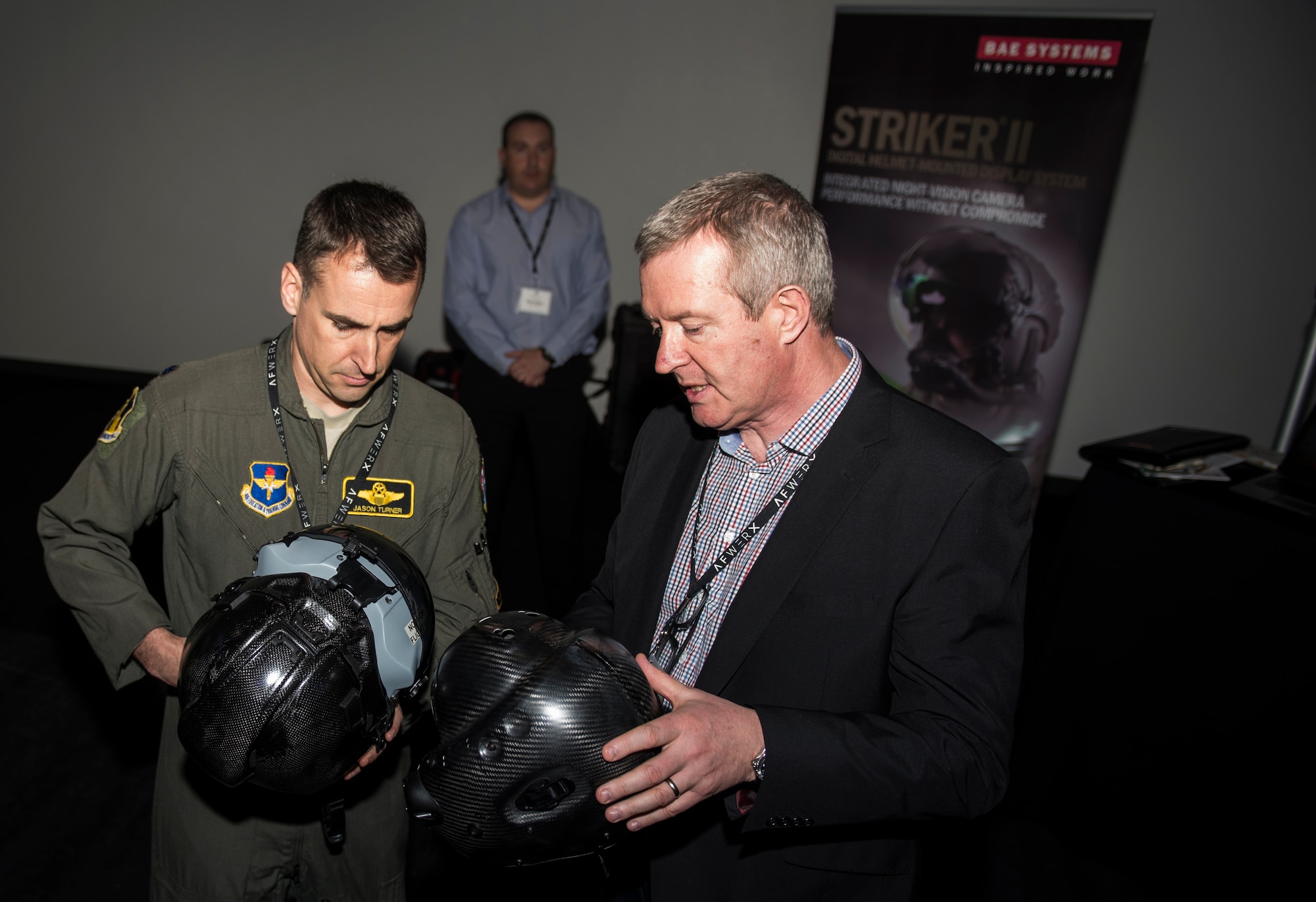 An Airman and an attendee of the AFWERX Helmet Challenge discuss new helmets at the Enclave Las Vegas, Nev., November 14, 2018. The final goal of the challenge is to enhance aircrew performance, aircrew safety and aircrew satisfaction. (U.S. Air Force photo by Airman 1st Class Bryan T. Guthrie)