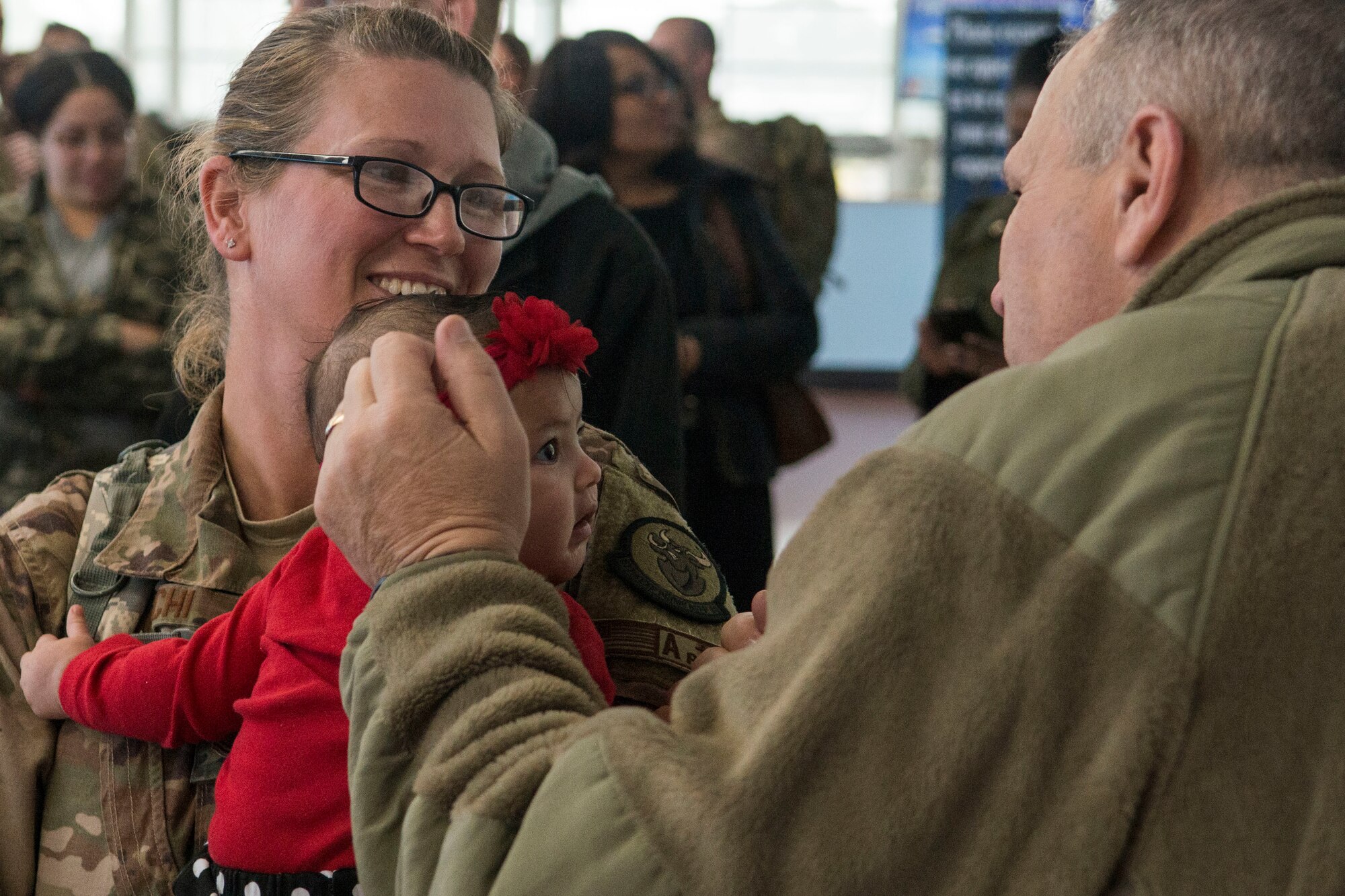 U.S. Air Force Lt. Col. Allen Spillers, 307th Bomb Wing inspector general, speaks with a returning deployer and her child in Shreveport, Louisiana, Jan. 14, 2019.  Spillers was part of a large crowd on hand to greet returning Reserve Citizen Airmen of the 307th Bomb Wing at Shreveport Regional Airport.  The Airmen have been deployed for the past several months in support of U.S. military operations. (U.S. Air Force photo by Greg Steele)