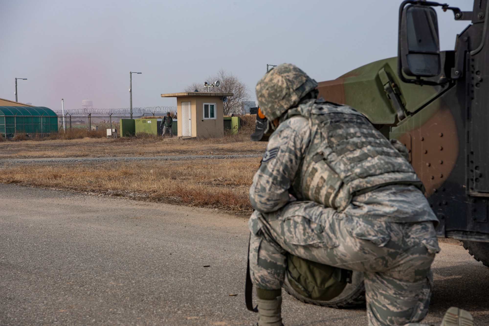 U.S. Air Force Staff Sgt. Chauncey Oliver, 8th Security Forces Squadron member, uses a humvee for cover during routine training at Kunsan Air Base, Republic of Korea, Jan. 14, 2019. The 8th Fighter Wing conducts frequent training to maintain the highest level of readiness. (U.S. Air Force photo by Staff Sgt. Levi Rowse/Released)