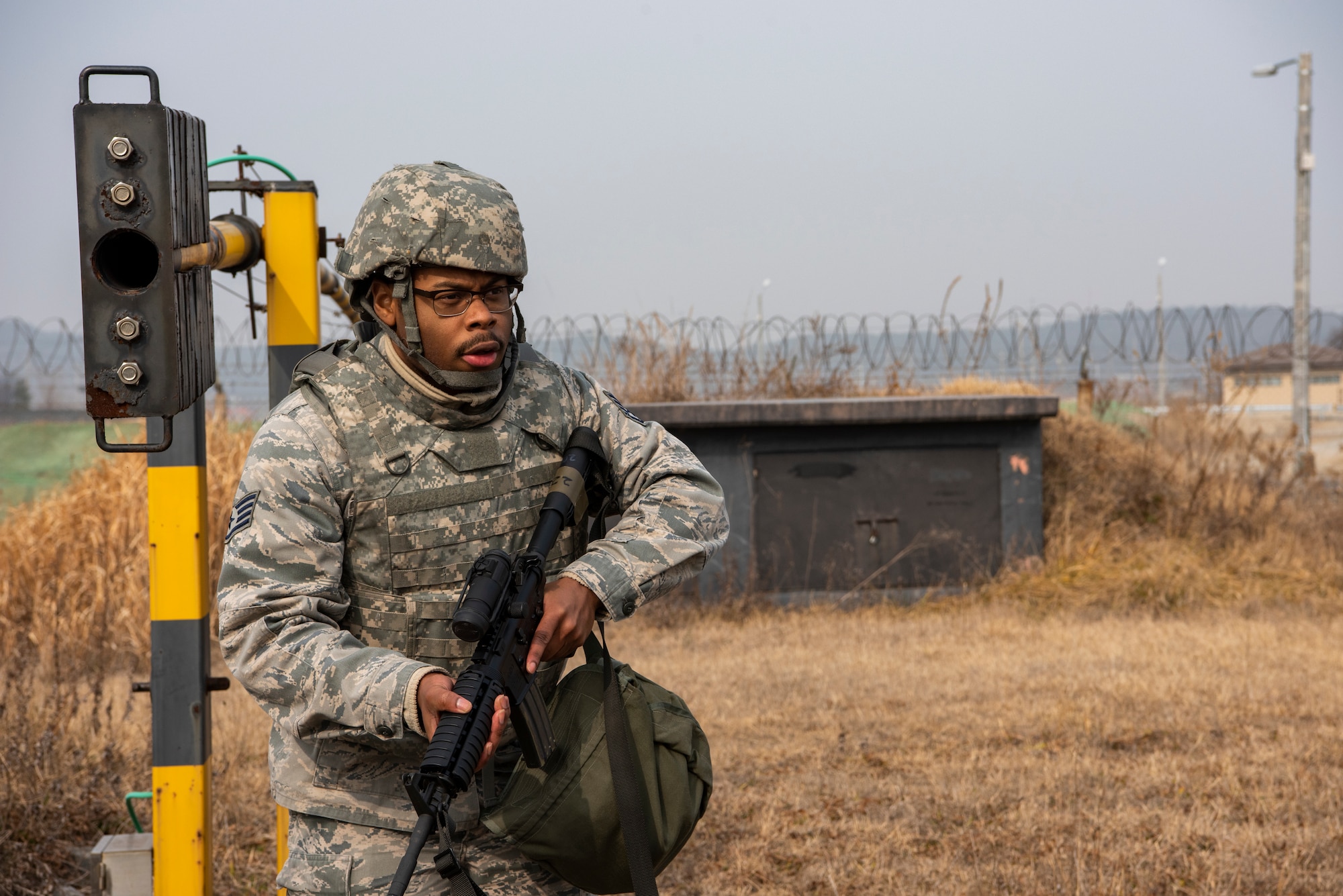 U.S. Air Force Staff Sgt. Chauncey Oliver, 8th Security Forces Squadron member, sweeps an area after an engagement with simulated hostile forces during routine training at Kunsan Air Base, Republic of Korea, Jan. 14, 2019. The 8th SFS frequently practices combat skills and tactics to ensure rapid response to contingencies. (U.S. Air Force photo by Staff Sgt. Levi Rowse/Released)