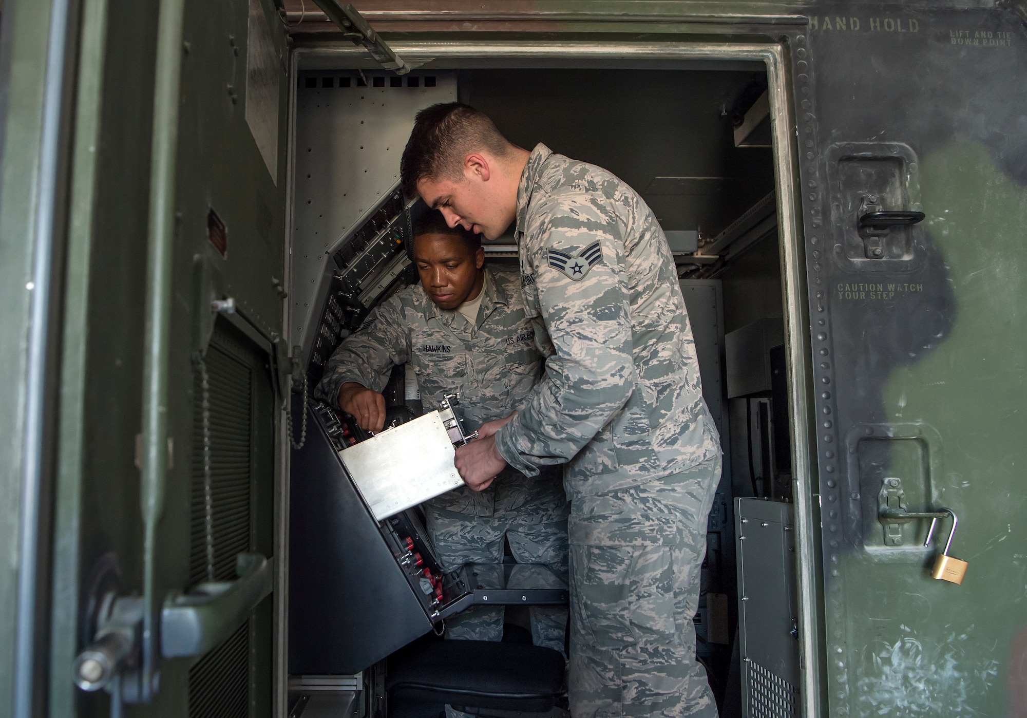 Senior Airman Collin Tully, foreground, 727th Expeditionary Air Control Squadron, Detachment 3 (EACS DET 3) radar maintainer, and Staff Sgt. Matthew Hawkins, 727th EACS DET 3 radar maintenance NCO in charge, conduct routine maintenance in the radar shelter of a transportable radar system (TPS-75) Jan. 14, 2019, at Al Udeid Air Base, Qatar. The 727th EACS consists of a team of 23 Airmen from seven different Air Force Specialty Codes. Together, they ensure TPS-75 radar systems are prepared to identify any aircraft within a 240 nautical mile range of Al Udeid. (U.S. Air Force Tech. Sgt. Christopher Hubenthal)