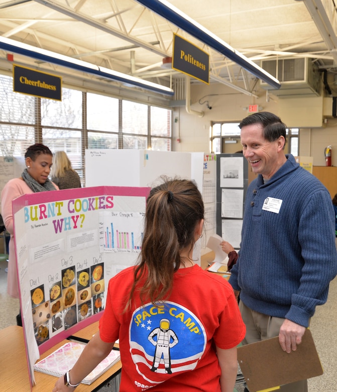 Russ Dunford, who manages strategic plans and integration at Huntsville Center, interviews sixth-grader Hannah Austin during Monte Sano Elementary School’s science fair for sixth-grade honor students Jan. 10, 2019, in Huntsville, Alabama.
