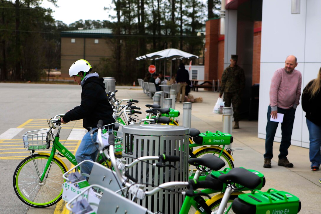 Representatives from Lime takes one of their bikes on for a ride outside of the main exchange on Marine Corps Air Station New River, Jan. 12, 2019. MCCS Lejeune-New River and Lime, a bicycle-sharing company, worked together to bring an environmentally friendly and inexpensive transportation alternative for Marines who lack vehicle transportation or wish to save money. (U.S. Marine Corps photo by Cpl. Jon Sosner)