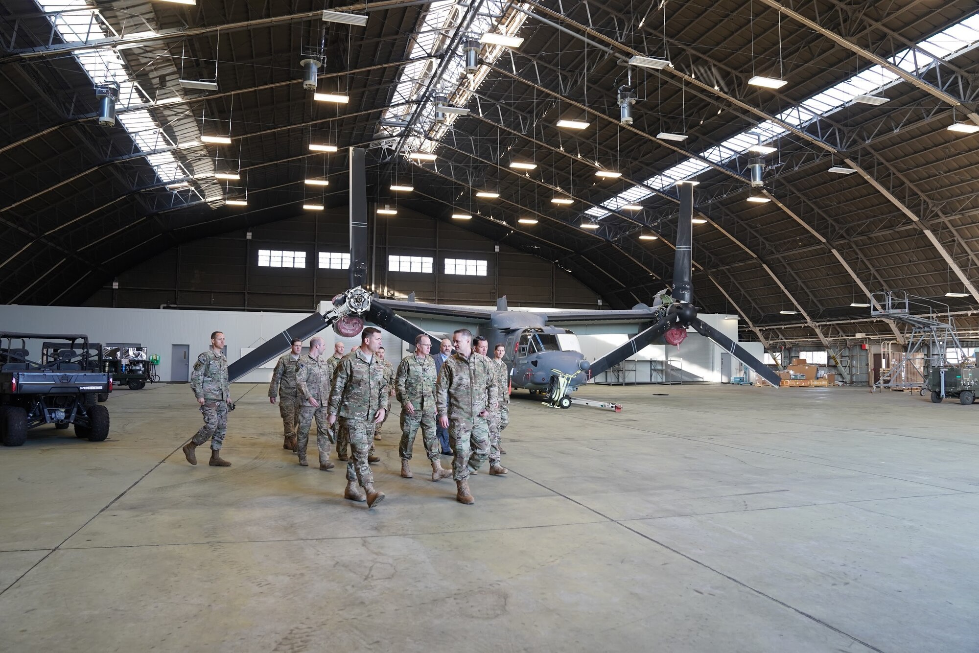 People touring an aircraft hangar.