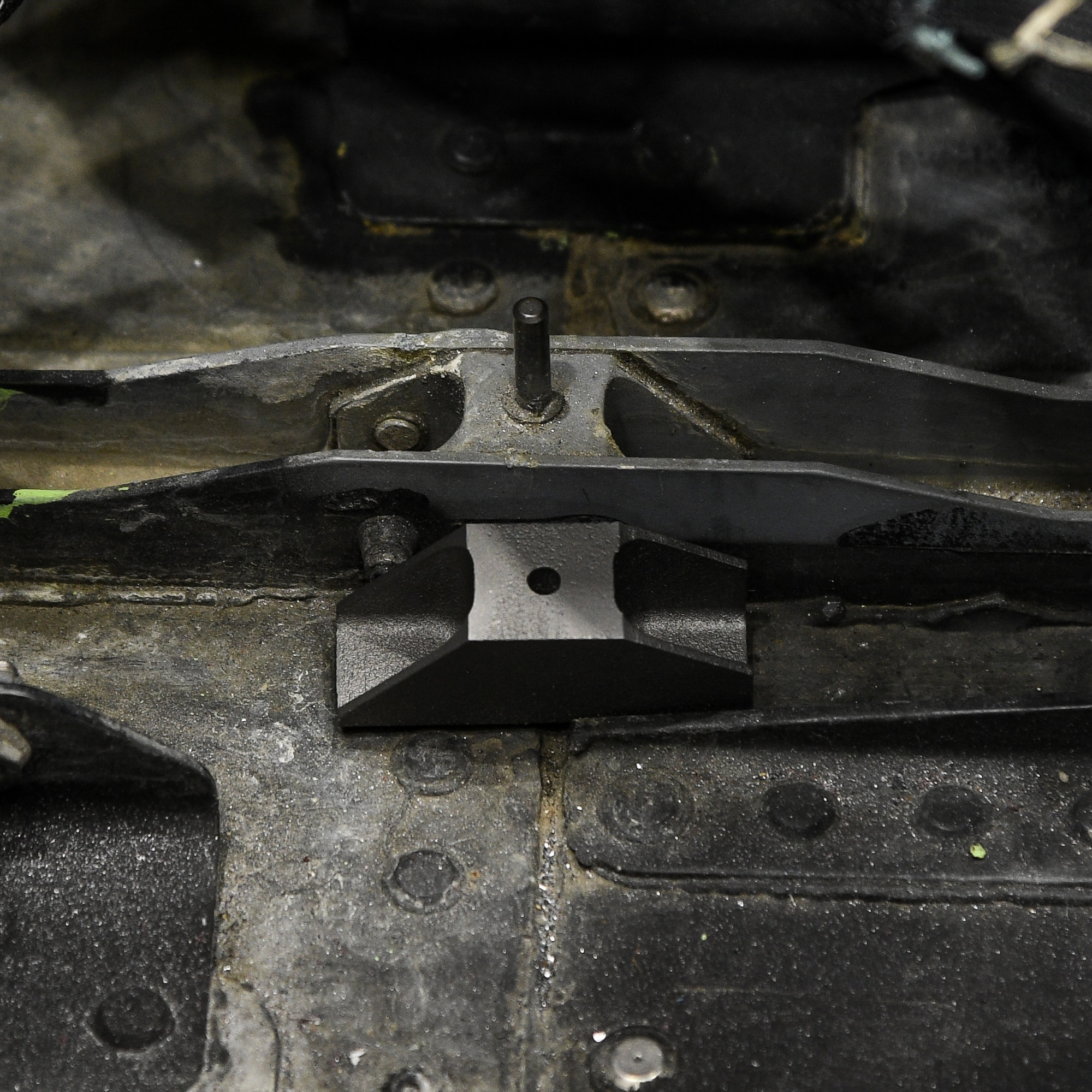 A new metallic 3D printed part alongside the aluminum part it will replace on an F-22 Raptor during depot repair at Hill Air Force Base, Utah, Jan 16, 2019. The new titanium part will not corrode and can be procured faster and at less cost than the conventionally manufactured part. (U.S. Air Force photo by R. Nial Bradshaw)