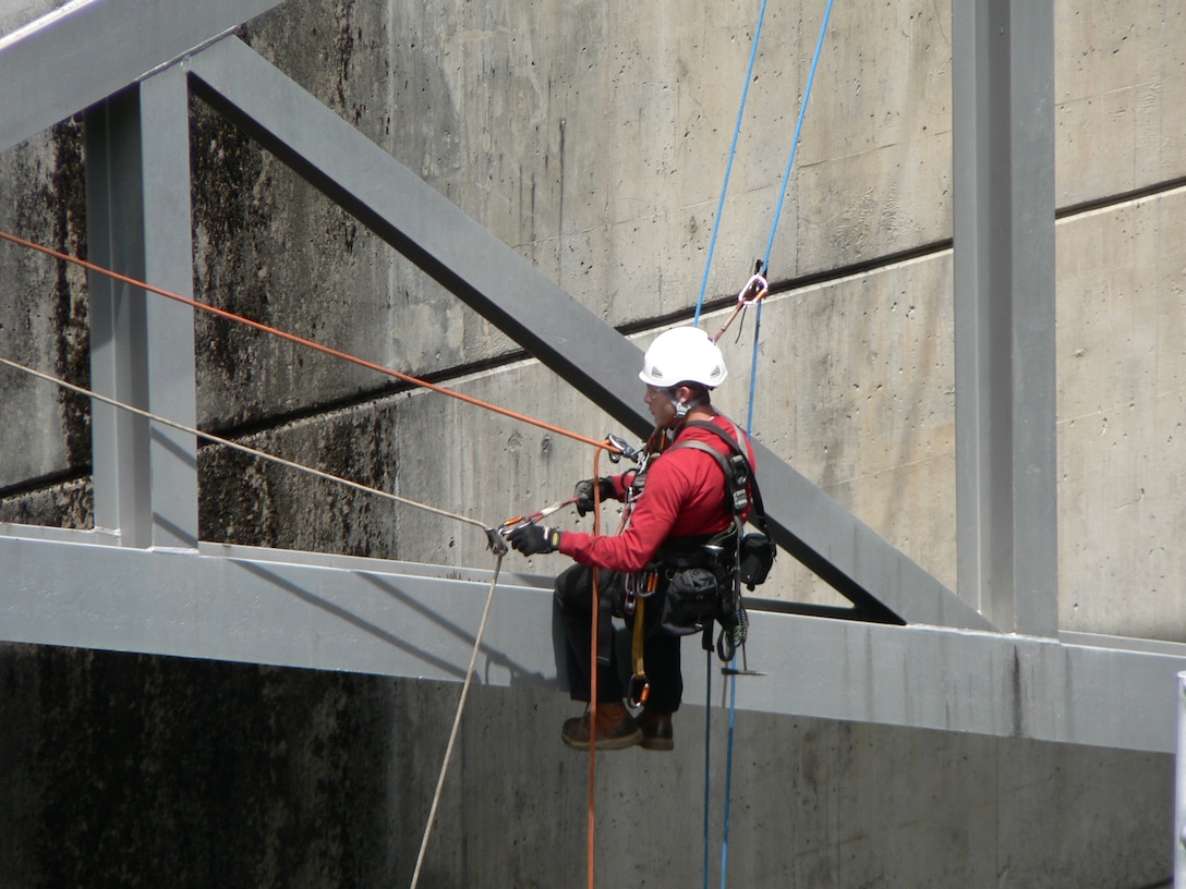 A Dam Safety Program inspector dangles from the face of a Willamette Valley dam as he assesses the condition of spillway gates, June 6, 2009. The dam safety assessment concluded gates could fail to open or could stick, which could affect how the dams released water. In 2010, the District began rehabilitating the gates.