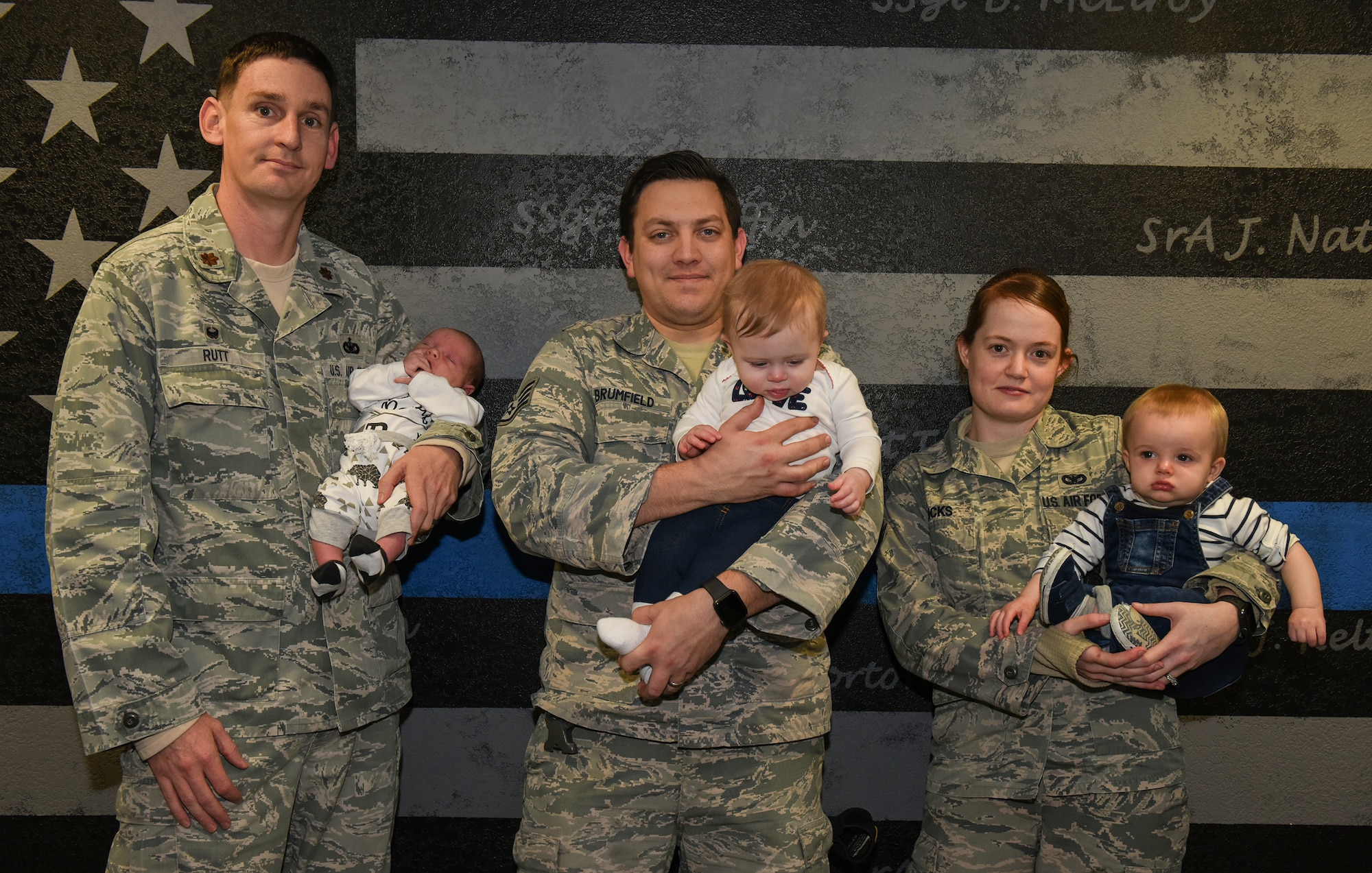 U.S. Air Force Maj. Brian Rutt, 423rd Security Forces commander, holds his baby with his defender team at RAF Alconbury, United Kingdom, Jan. 15, 2019. (U.S. Air Force photo by Airman 1st Class Jennifer Zima)