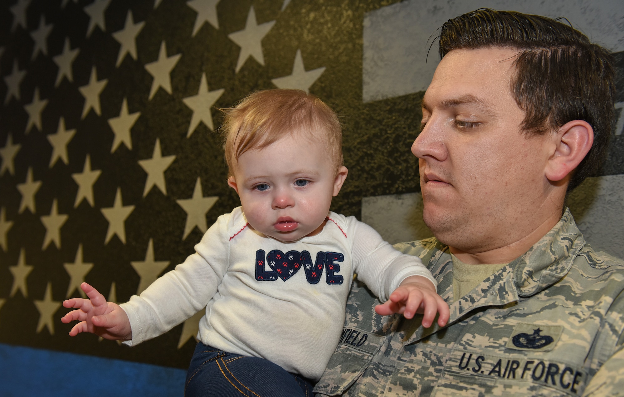 U.S. Air Force Staff Sgt. Tyler Brumfield, 423rd Security Forces Defender, holds his newborn baby at RAF Alconbury, United Kingdom, Jan. 15, 2019. (U.S. Air Force photo by Airman 1st Class Jennifer Zima)