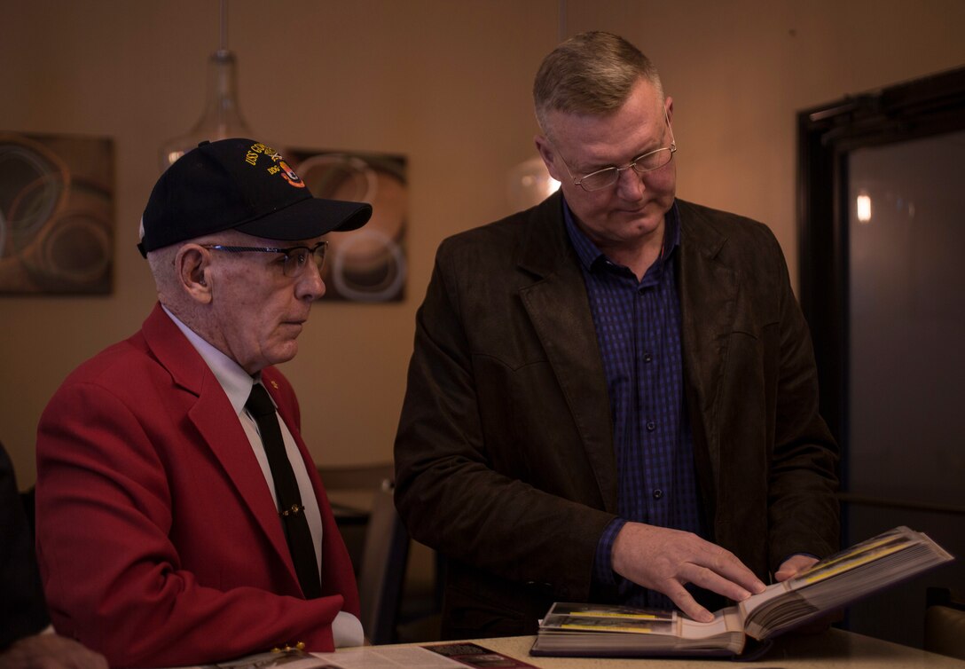 Retired Sgt. Maj. Edward F. Neas shares a photo memorabilia from the Vietnam War with Maj. Gen. Bradley S. James, commander of Marine Forces Reserve and Marine Forces North, in Edinburg, Texas, Jan. 14, 2019. Neas served in the Marine Corps on active duty from 1966-1969 and afterward served in the Marine Forces Reserve for 26 years. (U.S. Marine Corps photo by Cpl. Tessa D. Watts)