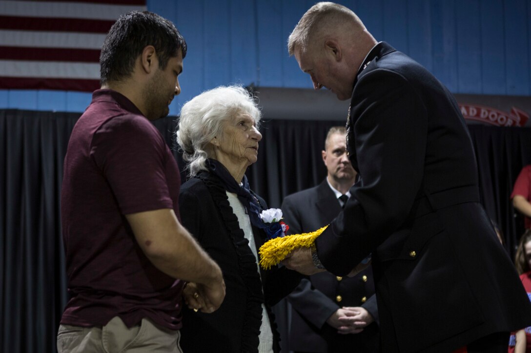 Maj. Gen. Bradley S. James, commander of Marine Forces Reserve and Marine Forces North, presents the Medal of Honor flag to Sgt. Alfredo Cantu Gonzalez’s mother, Dolia Gonzalez, at the Freddy Gonzalez Elementary school in Edinburg, Texas, Jan. 14, 2019. Gonzalez served two tours in the Vietnam War and was killed on Feb. 4, 1968. (U.S. Marine Corps photo by Cpl. Tessa D. Watts)