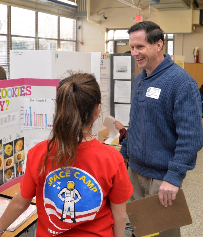 Russ Dunford, who manages strategic plans and integration at Huntsville Center, interviews sixth-grader Hannah Austin during Monte Sano Elementary School’s science fair for sixth-grade honor students Jan. 10, 2019, in Huntsville, Alabama.