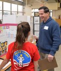 Russ Dunford, who manages strategic plans and integration at Huntsville Center, interviews sixth-grader Hannah Austin during Monte Sano Elementary School’s science fair for sixth-grade honor students Jan. 10, 2019, in Huntsville, Alabama.
