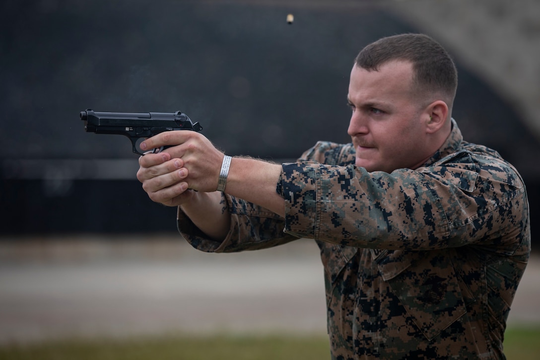 U.S. Marine Corps Staff Sgt. Brandon Brooks, an air traffic controller with Marine Corps Air Station Kaneohe Bay, fires a M9 Berretta Pistol at targets during the Marine Corps Marksmanship Competition, Pacific (MCMCP) at Kaneohe Bay Range Training Facility, Marine Corps Base Hawaii, Jan. 14, 2019. The MCMCP is one of four division matches throughout the U.S. Marine Corps in which U.S. Service members and the Pacific’s best shooters participate in a small arms marksmanship competition each year. Each course of fire is unique utilizing rifle and pistol while being timed to select the top shooters. (U.S. Marine Corps photo by Sgt. Jesus Sepulveda Torres)