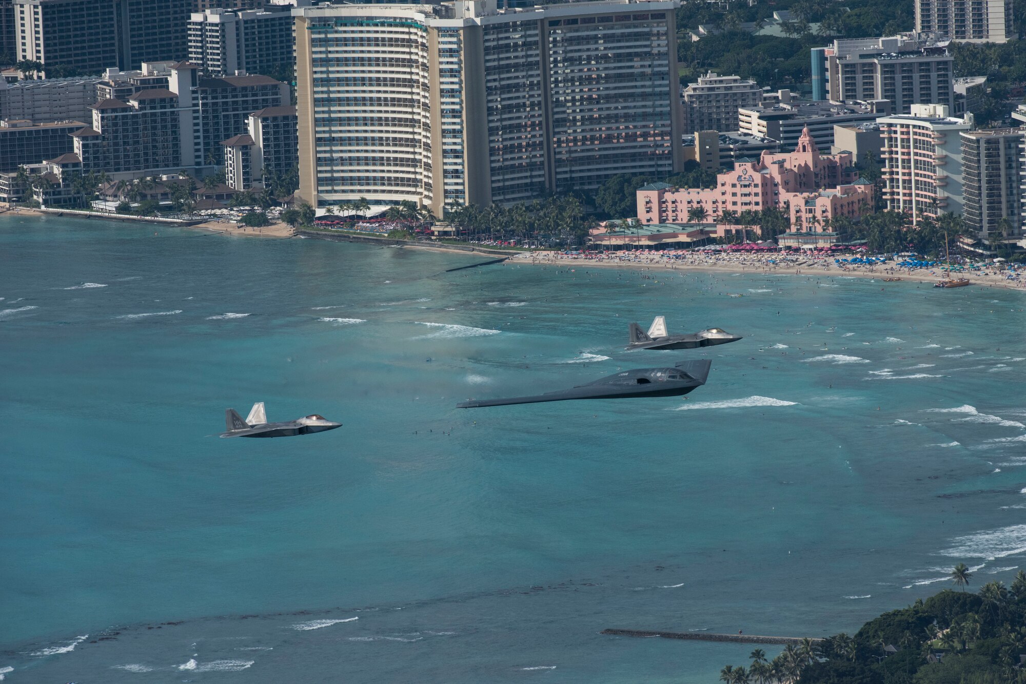 A U.S. Air Force B-2 Spirit bomber deployed from Whiteman Air Force Base, Missouri, and two F-22 Raptors from the 199th Fighter Squadron at Joint Base Pearl Harbor-Hickam, Hawaii, fly in formation near Diamond Head State Monument, Hawaii, after completing interoperability training, Jan. 15, 2019.