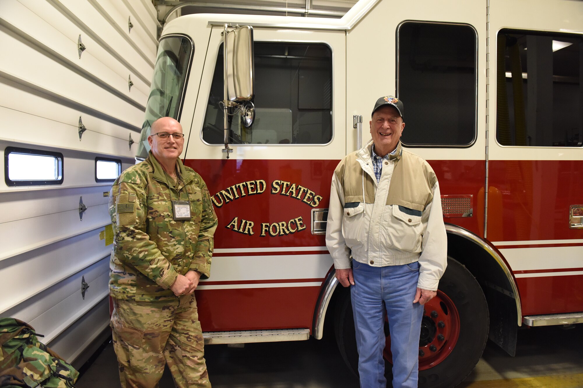 Master Sgt. Gary Shannon assigned to the 171st Air Refueling Wing near Pittsburgh and Retired Chief Master Sgt. Edward “Buck” Boyd pose for a photo in front of a fire department vehicle, Jan. 15, 2019