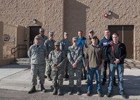 Airmen pose for a group photo outside of building 788, Jan. 11, 2019, on Holloman Air Force Base, N.M. Col. Brian Patterson, 49th Wing vice commander, and Chief Master Sgt. Sarah Esparza, 49th Wing command chief, celebrated the opening of the Special Victims’ Counsel’s new office. (U.S. Air Force photo by Airman Autumn Vogt)