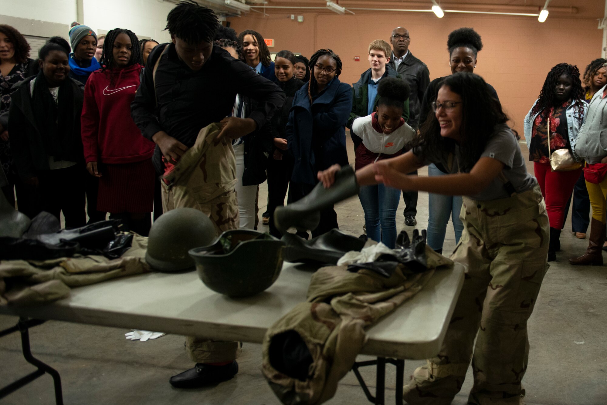 Two middle school students race to put on Mission Oriented Protective Posture (MOPP) gear, at Shaw Air Force Base, S.C., Jan. 11, 2019.