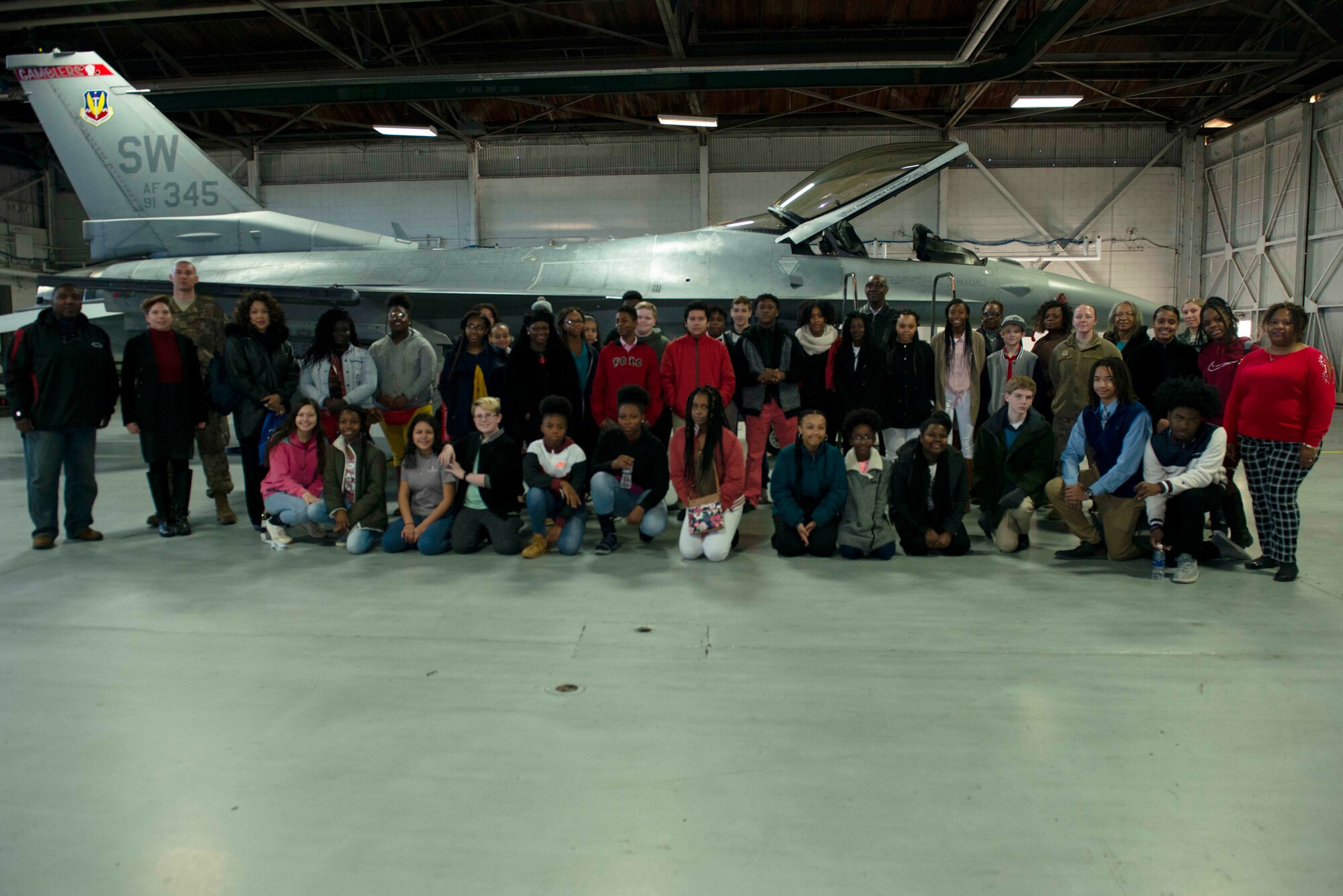 Students from five local middle schools stand in front of an F-16 Fighting Falcon at Shaw Air Force Base, S.C., Jan. 11, 2019.