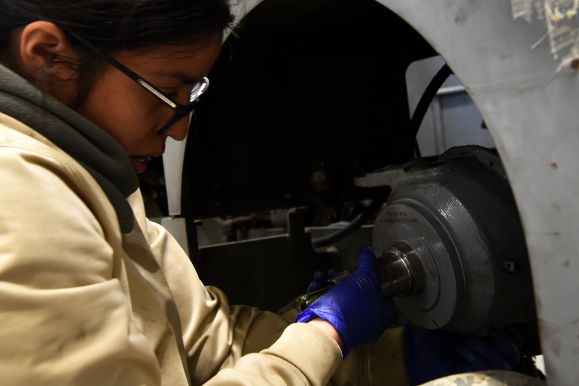 U.S. Air Force Airman 1st Class Fabiola Barba, 20th Equipment Maintenance Squadron aerospace ground equipment (AGE) technician, prepares to put a wheel back on a munitions jammer 1-B bomb lift at Shaw Air Force Base, S.C., Jan. 16, 2019.