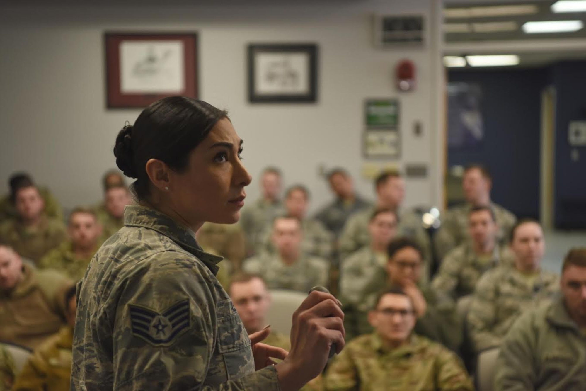 Staff Sgt. Symphony Leyk, 5th Force Support Squadron Airman Leadership School Instructor, shares memories while instructing her students at Minot Air Force Base, N.D., Jan. 15, 2019,. Airmanship, standards, discipline and self-awareness are a few topics covered throughout the five-week ALS course. (U.S. Air Force photo by Airman 1st Class Heather Ley)