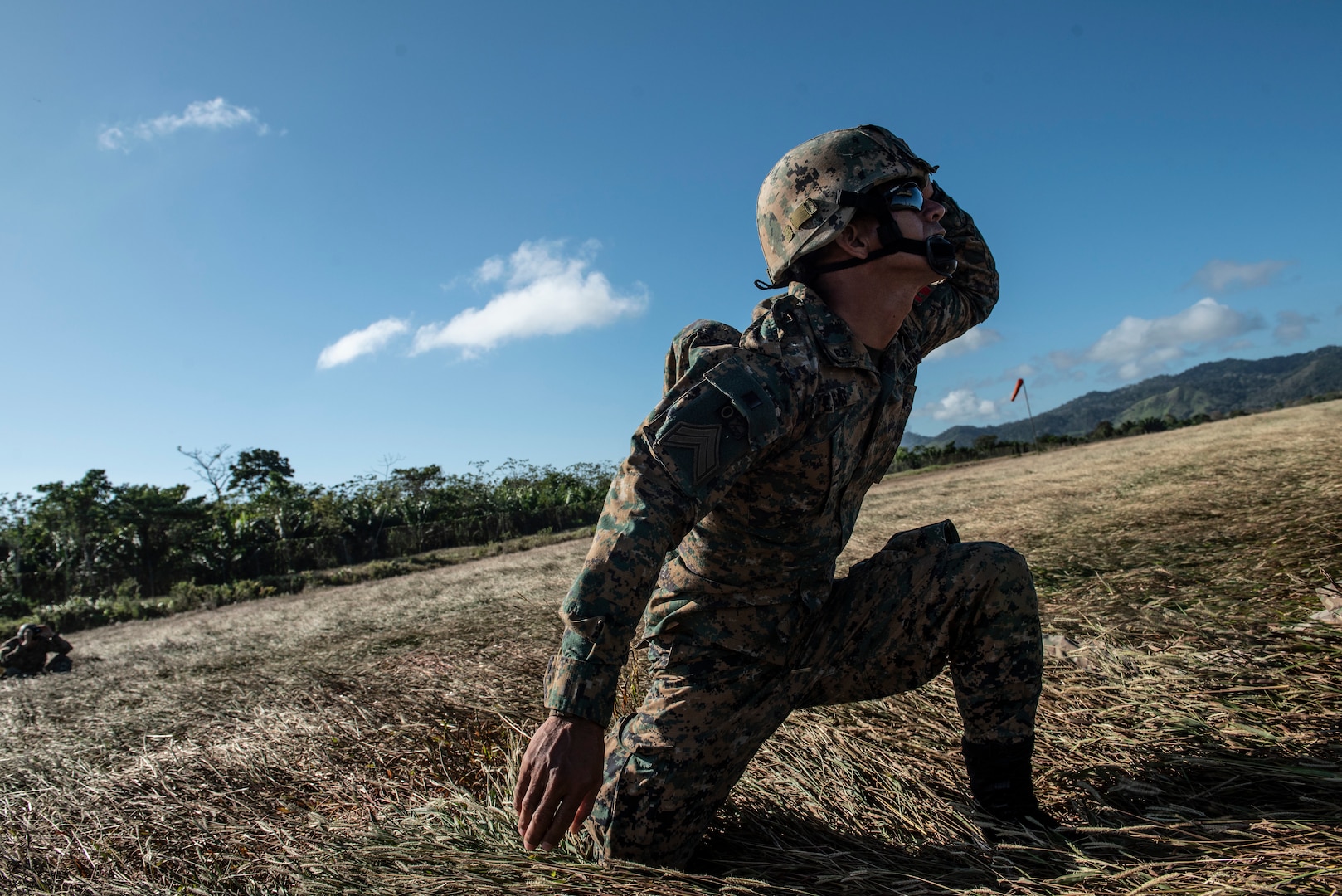 A Republic of Panama National Border Service agent takes cover while a CH-47 Chinook lifts supplies off a runway to carry to the Darien Province, Jan. 11, 2019.