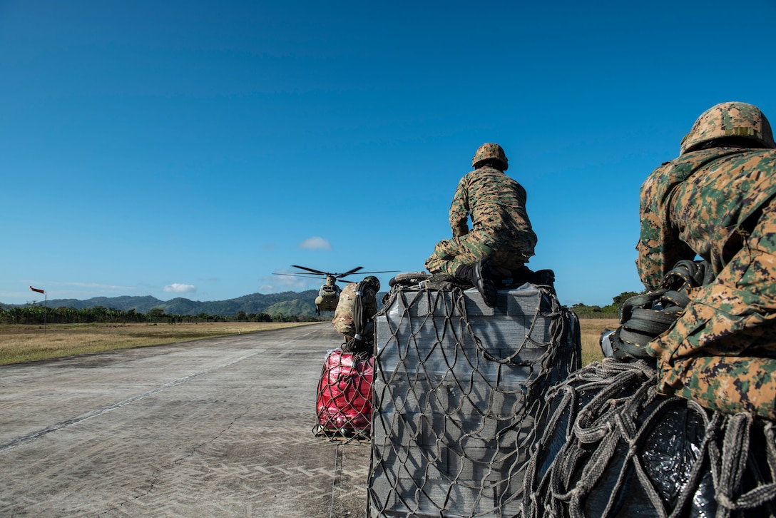 Agents from Panama’s National Border Service wait to load slings onto a U.S. Army CH-47 Chinook headed to the Darien Province in the Republic of Panama, Jan. 11, 2019.