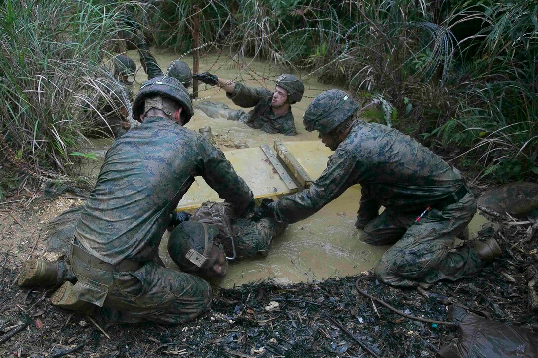 Marines work together to complete an endurance course.