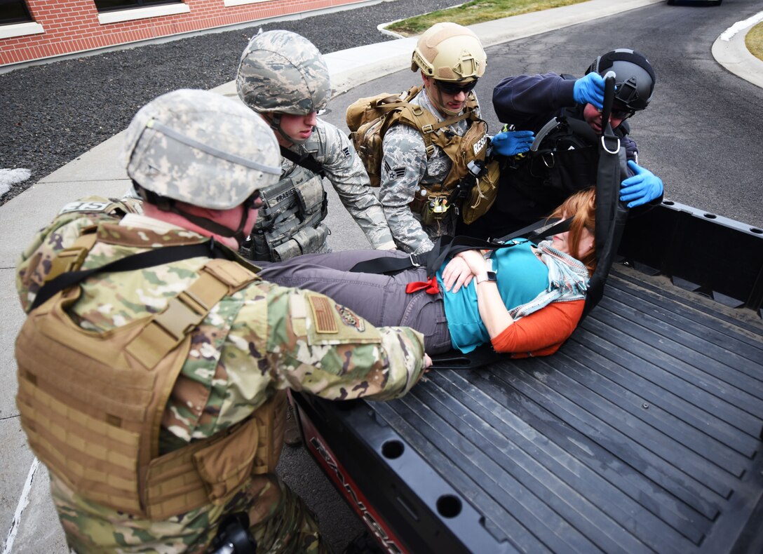Members of the 92nd Security Forces Squadron and 92nd Civil Engineer Squadron fire department, aid a victim during an active shooter exercise at Fairchild Air Force Base, Washington, Jan. 16, 2019.