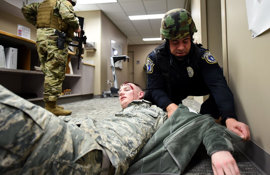 Aaron Watkins, 92nd Security Forces Squadron police officer, aids a victim during an active shooter exercise at Fairchild Air Force Base, Washington, Jan. 16, 2019.