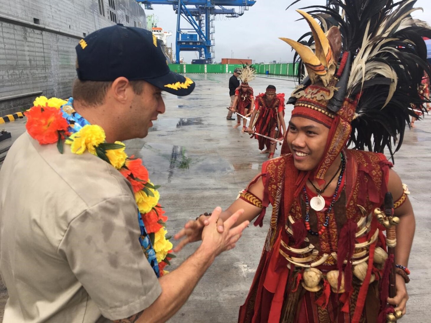 Civilian mariner Capt. Adam Streeper, ship’s master of the expeditionary fast transport ship USNS Brunswick (T-EPF 6), shakes hands with members of a local Minahasa dance troupe after the ship arrived in Bitung, Indonesia, for a scheduled port visit. Brunswick is one of three expeditionary fast transport ships in the U.S. 7th Fleet area of responsibility with a mission of providing rapid intra-theater transport of troops and military equipment.