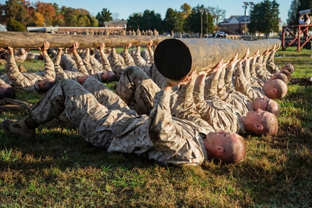 U.S. Marine officer candidates with the Officer Candidate School (OCS) conduct log presses for training at Marine Corps Base Quantico, Va., Nov. 7, 2018. The mission of OCS is to educate and train officer candidates in order to evaluate and screen individuals for qualities required to become commissioned as a Marine Corps Officer. (U.S. Marine Corps photo by Lance Cpl. Yuritzy Gomez)