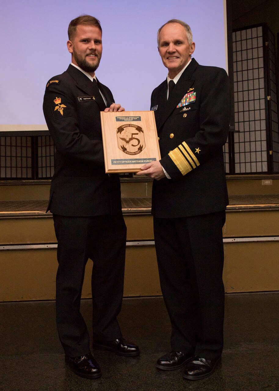 YOKOSUKA, Japan (Jan, 17 2019) - Vice Adm. Phill Sawyer poses with Royal New Zealand Navy Petty Officer Medic Matthew Purcell at the announcement luncheon during 7th Fleet Sailor of the Year competition. The 7th Fleet Sailor of the Year Week is designed to share with these outstanding Sailors the unique operational environment in the 7th Fleet as well as enhance regional partnerships with like-minded forces.