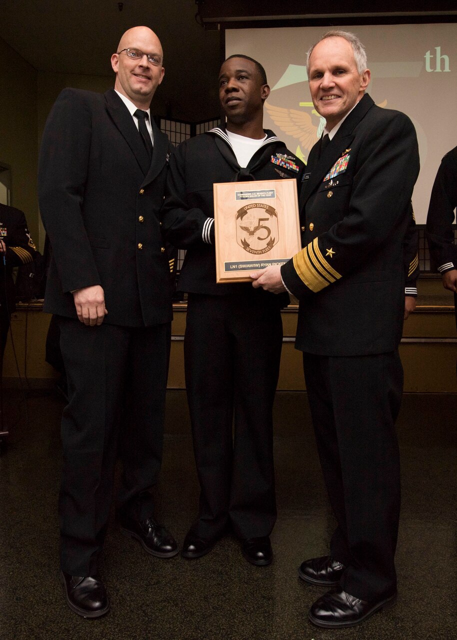 YOKOSUKA, Japan (Jan, 17 2019) - Vice Adm. Phil Sawyer(right), along with Fleet Master Chief Tobi Howat(left), poses with Legalman 1st Class Ryan Pickens at the announcement luncheon during 7th Fleet Sailor of the Year competition. The 7th Fleet Sailor of the Year Week is designed to share with these outstanding Sailors the unique operational environment in the 7th Fleet as well as enhance regional partnerships with like-minded forces.