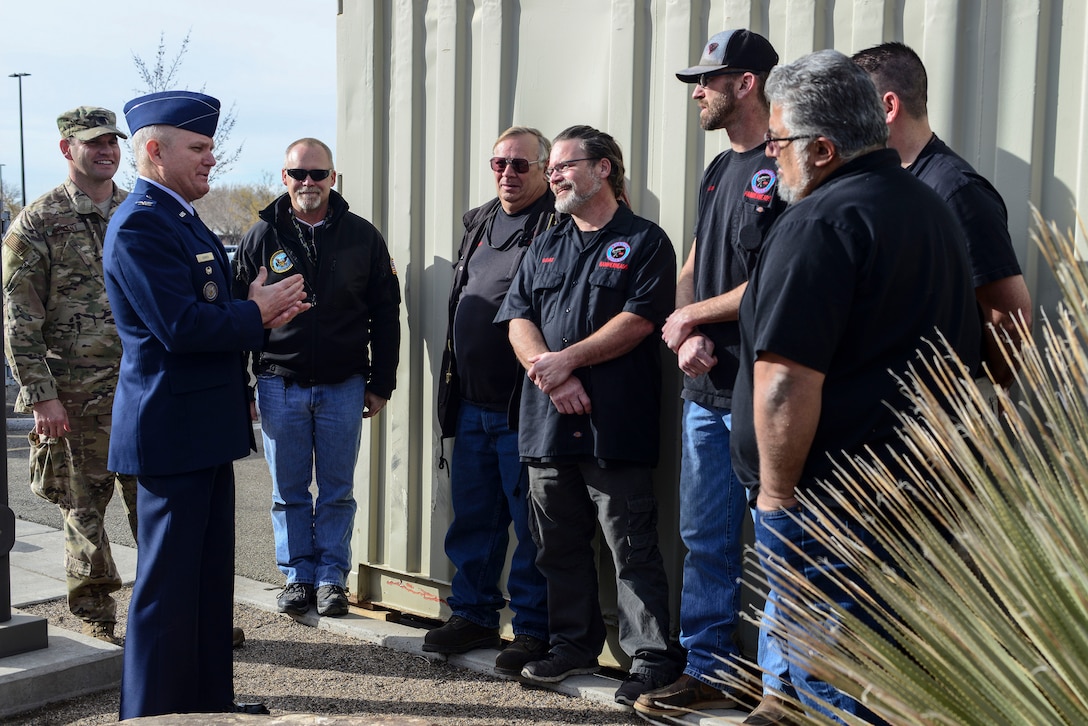 Center, Col. Mark E. Bowen, Defense Nuclear Weapons School commandant, talks to members of the 58th Special Operations Wing’s Monster Garage after the dedication ceremony at the schoolhouse at Kirtland Air Force Base, N.M., Jan.
10. The Monster Garage members helped replicate the iconic Mk6 Atomic Bomb training device, which was unveiled during the ceremony. (U.S. Air Force photo by Staff Sgt. Kimberly Nagle)