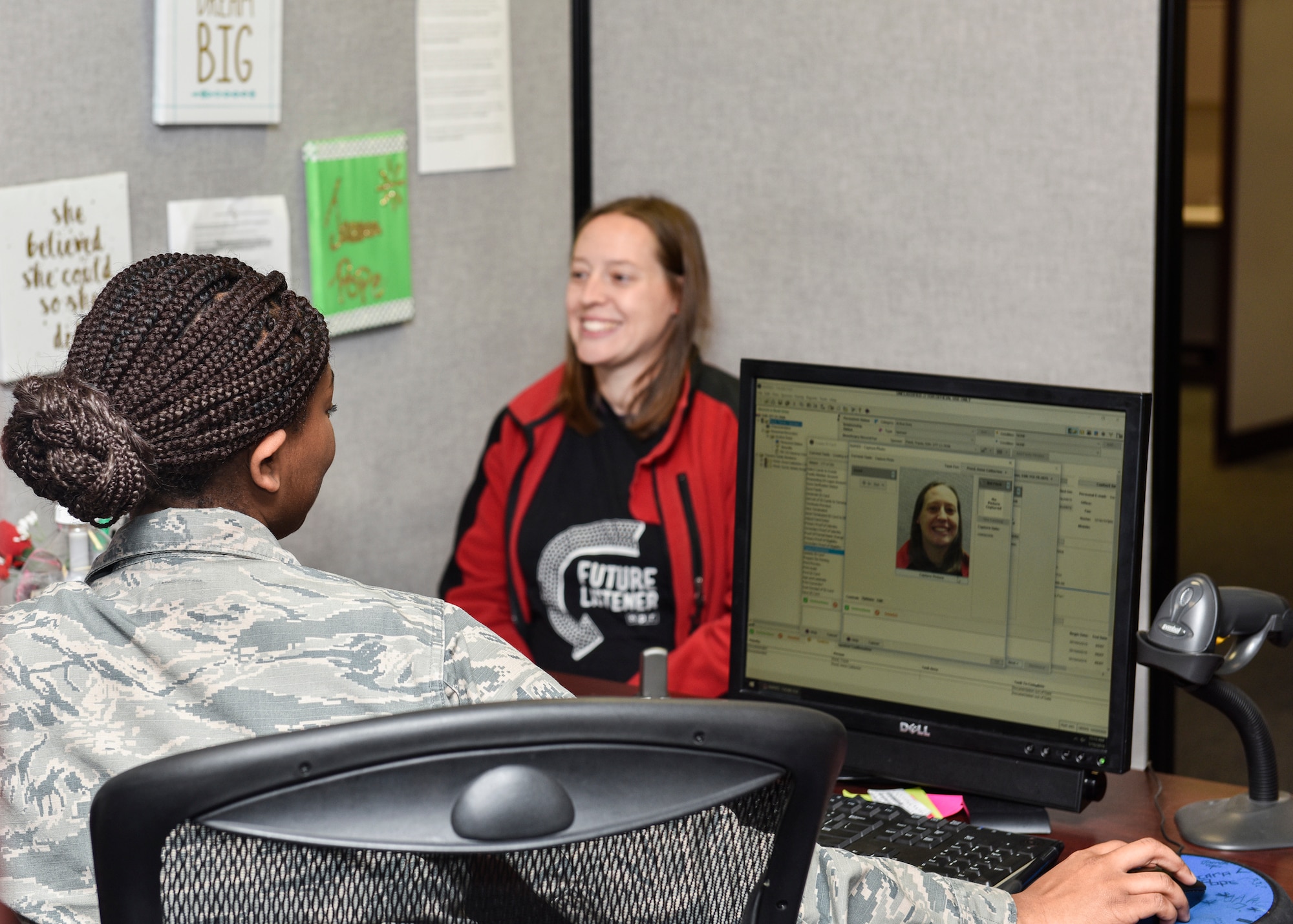 Dr. Nan Pond gets her picture taken for a new ID by Airman 1st Class Jacara Pope, 377th FSS customer service technician, at Kirtland Air Force Base, N.M., Jan. 15, 2019. Kirtland’s MPF work also includes making ID cards for service members, contractors, dependents and retirees, DEERS updates such as new dependencies and marriages, leave approval, line of duty determinations, special leave accrual, on base transportation, resetting common access cards and helping dependents gain U.S. citizenship. (U.S. Air Force photo by Airman 1st Class Austin J. Prisbrey)