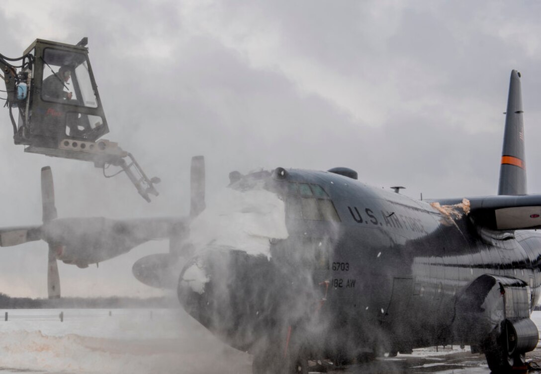 Tech. Sgt. Andrew Smith, a 182nd Aircraft Maintenance Squadron, Illinois Air National Guard aerospace maintenance specialist, de-ices a C-130H3 Hercules on the flightline at the 182nd Airlift Wing in Peoria, Ill., Jan. 13, 2019. The Peoria area received a record-breaking 17.2 inches of snowfall between Jan. 11 and 12, according to National Weather Service preliminary reports. (U.S. Air National Guard photo by Airman 1st Class Jason Grabiec)
