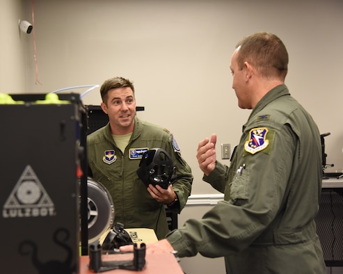 Maj. Ryan Brewer, 14th Flying Training Wing director of innovation, speaks to Col. Derek Stuart, 14th Operations Group commander, during the Spark Cell grand opening Oct. 19, 2018, on Columbus Air Force Base, Mississippi. The need of innovation at Columbus AFB led to a partnership with the 333rd Training Squadron at Keesler AFB, Mississippi, to create new processes and contribute different concepts.  (U.S. Air Force photo by Melissa Doublin)