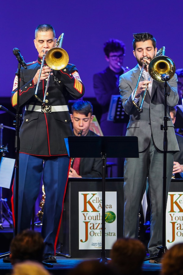U.S. Marine Corps Gunnery Sgt. Ken Ebo, a musical technical assistant for the 8th Marine Corps District, performs alongside a high school musician from the Keller school district, during the Keller Area Youth Jazz Orchestra concert at Venture Church in Keller, Texas, on Jan. 6.